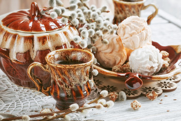 cups of coffee with a pussy willow, candies and a zephyr