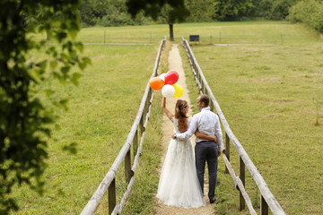 Joyful bride and groom embracing outdoor