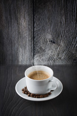 Cup of coffee on wooden background