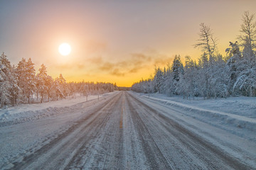 Fototapeta na wymiar Colorful Lapland arctic day on winter road, Finland