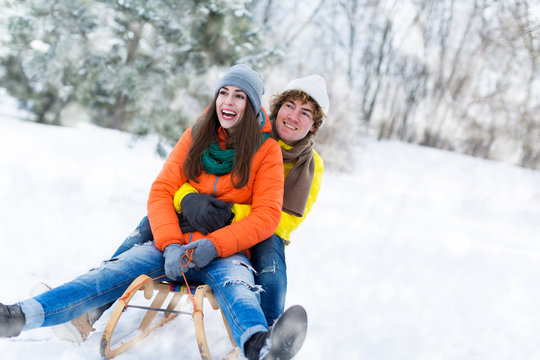 Couple with sled in snow