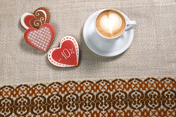 Specially for you. Top view shot of a cup of coffee with red heart shaped cookies on the restaurant table