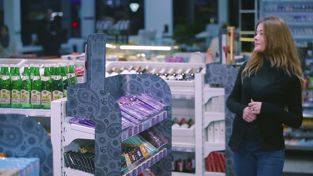 Girl stealing candy bar from shop
