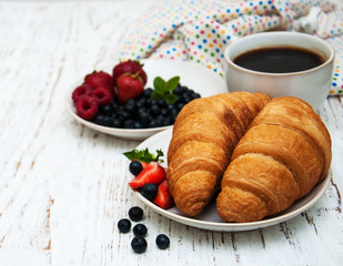 Fresh berries, coffee and croissant