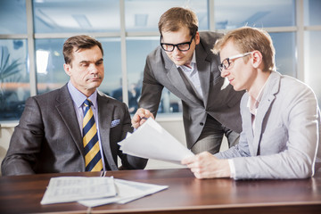 three businesspeople interacting at meeting