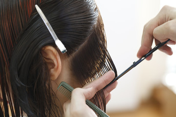 stylist hairdresser doing haircut