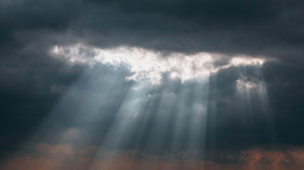 Light beams shining trough the clouds