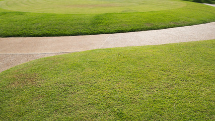 Bright green grass field and walkway for background wallpaper