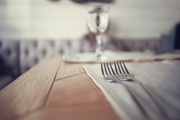 cutlery on the table in a restaurant table setting, knife, fork, spoon, interior