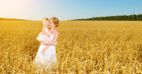 happy family in summer nature. Mother and baby daughter in the w