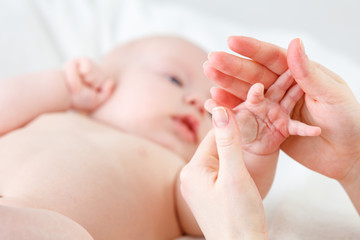Obraz na płótnie Canvas concept of parental love. baby hand holding finger of mother