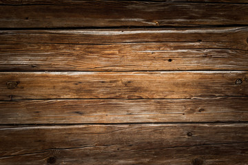 Fototapeta na wymiar Holz Hintergrund rustikal, Bretterwand aus warmen Holz, Vignettierung