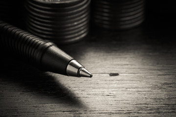 Fototapeta premium money concept coins and pen with filter effect retro vintage sty