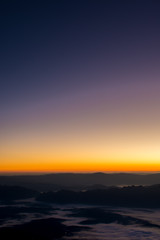 Dramatic sunset and sunrise sky on mountain and fog.