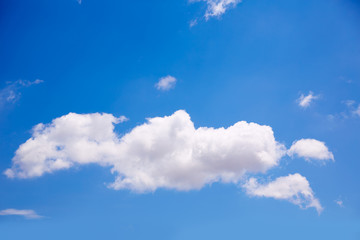 Single big cumulus cloud in blue sky