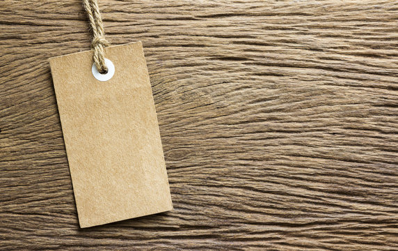 Blank tag tied on wooden background