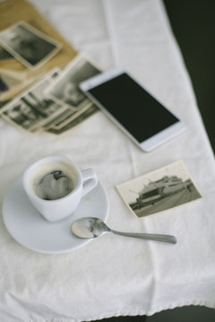 Cup of coffee and photographs on the table