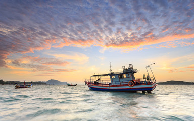 Fototapeta premium Fishing boat stand at sunrise beach in Phuket