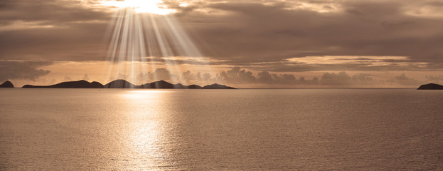 Caribbean island sunset with suns rays panorama