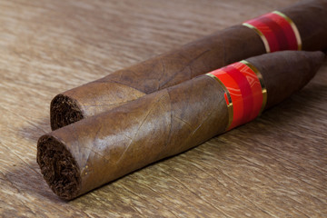 Different cigars on the old wooden table