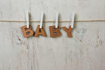 the word baby and clothespins on a white background old
