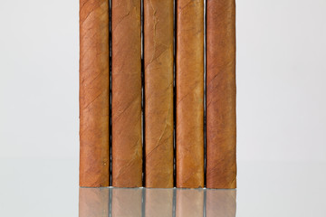 Different cigars on a  glass desk