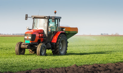  tractor fertilizing in field