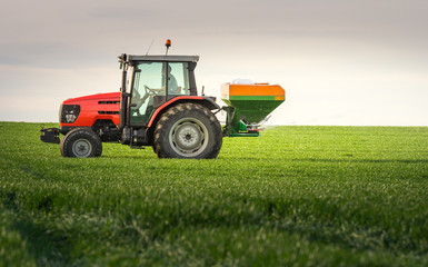 Fototapeta premium tractor fertilizing in field