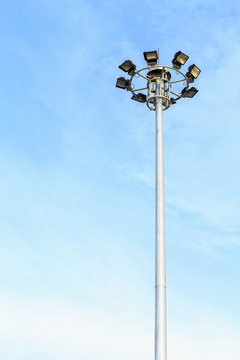 Spot-light tower at the road on blue sky
