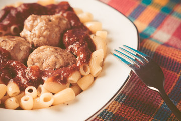 Pasta and meatballs with tomato sauce. Toned image.