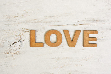 the word love on a white background old wooden