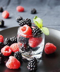 black berries and raspberries in a glass cup