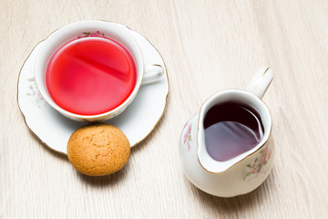 Cup of tea and cookies on wooden table