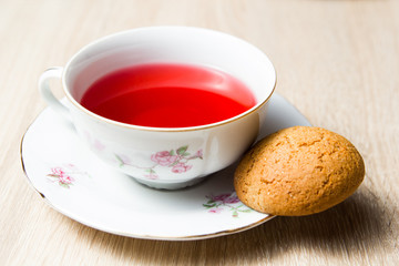 Cup of tea and cookies on wooden table