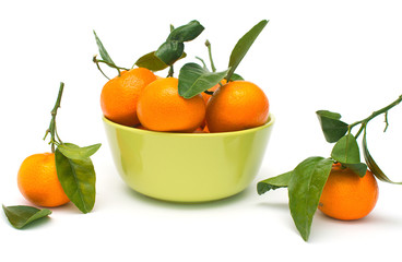 Clementines with green leaves on the table