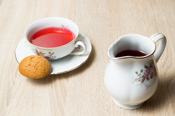 Cup of tea and cookies on wooden table