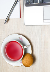 Cup of tea with cookie, tea break in office