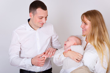 Happy and smiling Young Parents playing With Their Baby boy 4 month old on white background. Concept happy family