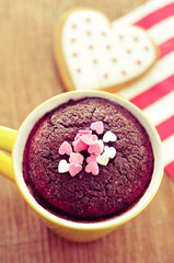 Obraz na płótnie Canvas chocolate mug cake and heart-shaped cookie, filtered