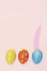 decorated easter eggs and feather