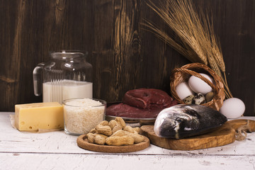 Healthy food, natural sources of protein over wooden table. Selective focus