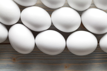 White eggs on wooden background