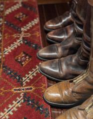 Worn Leather Boots with Patterned Carpet