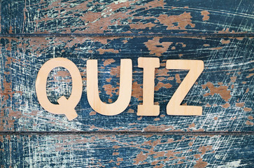 Word quiz written with wooden letters on rustic surface
