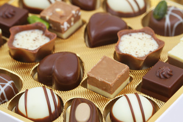Assorted white and milk chocolates, closeup
