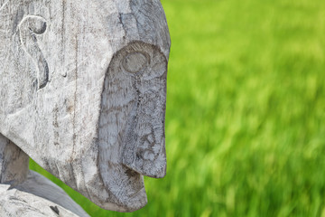 Wood carved man profile - part of old traditional outside decoration of houses on islands of East...