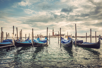Gondolas in lagoon of Venice and San Giorgio island in background, Italy, Europe, Vintage filtered style   © AR Pictures