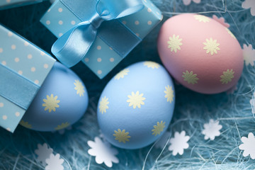 Easter eggs and gift box on blue background