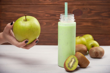 Healthy fruit smoothie on rustic wood table.