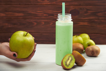 Healthy fruit smoothie on rustic wood table.